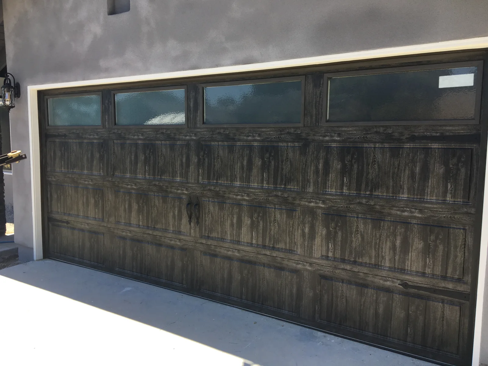 Contemporary glass-panel garage door installation in San Diego County