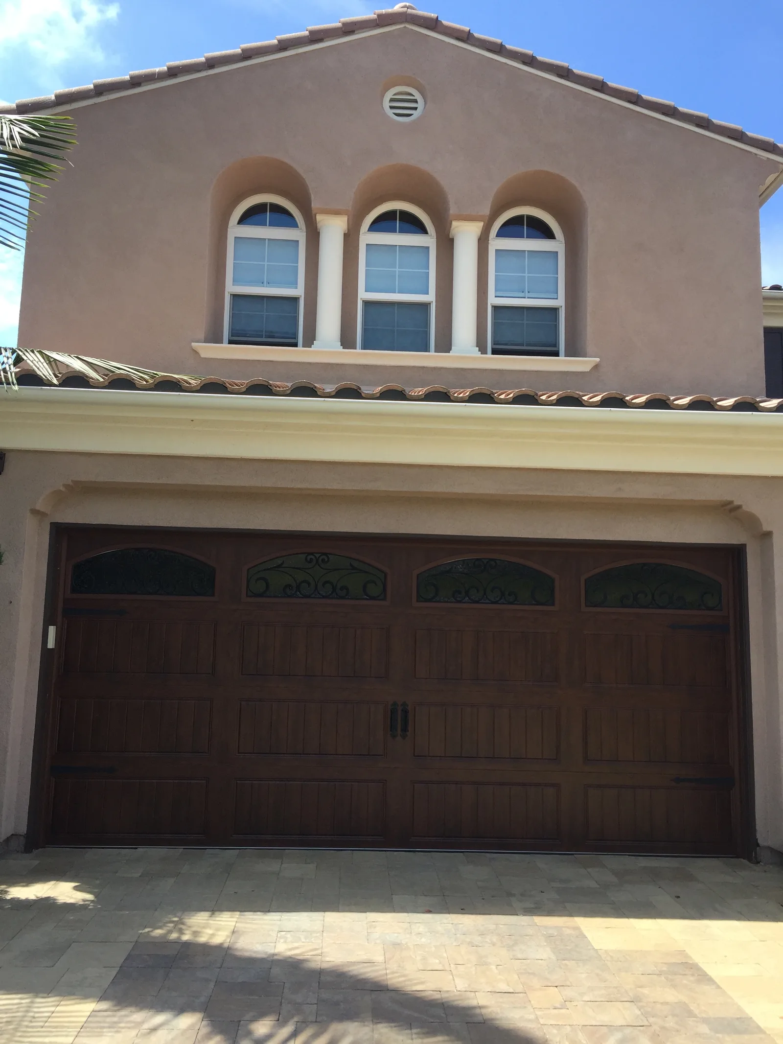 Wood-look garage door installation by Castle Garage Doors